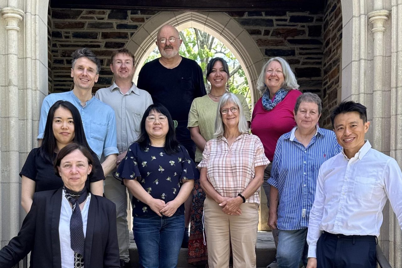 The eleven instructors in the CAST Fellows 2024-25 cohort, standing on an outdoor set of steps.