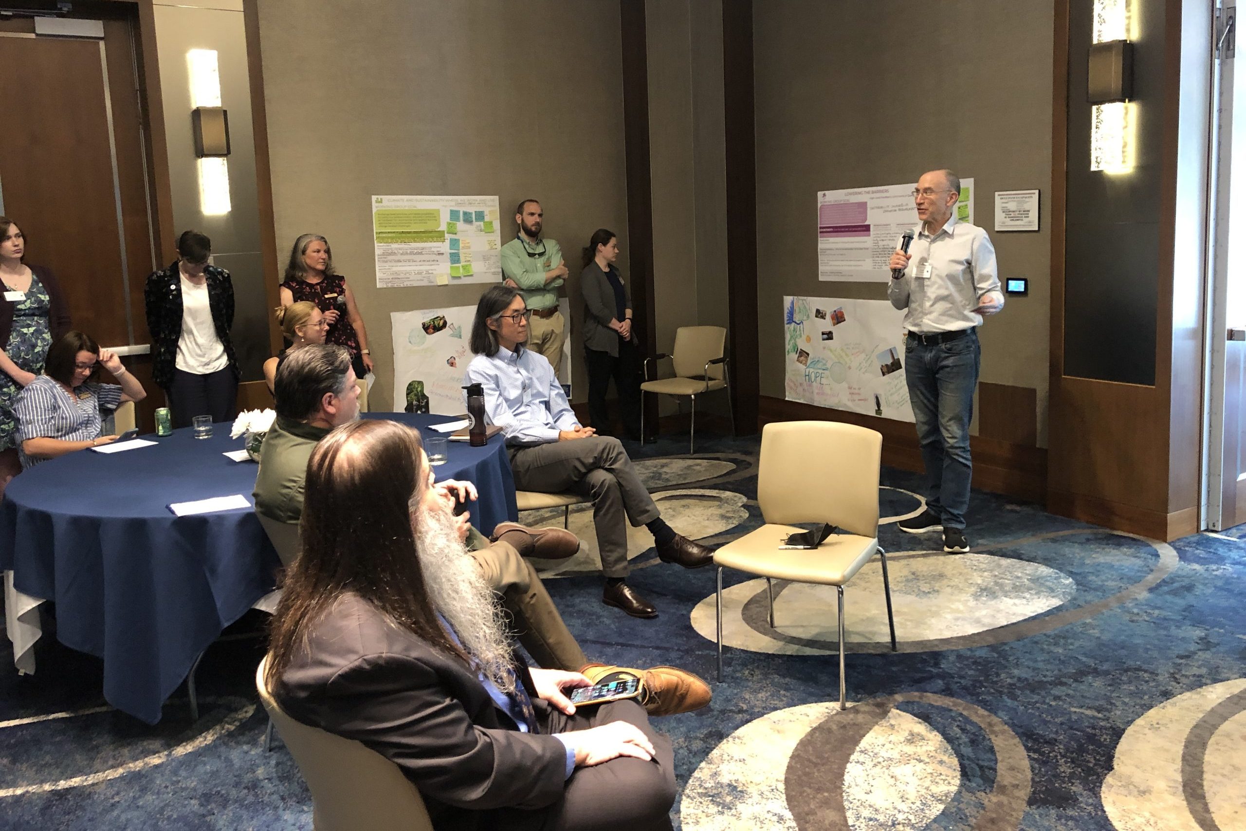 A group of participants at the "All In" symposium discussing their ideas for climate in higher education.