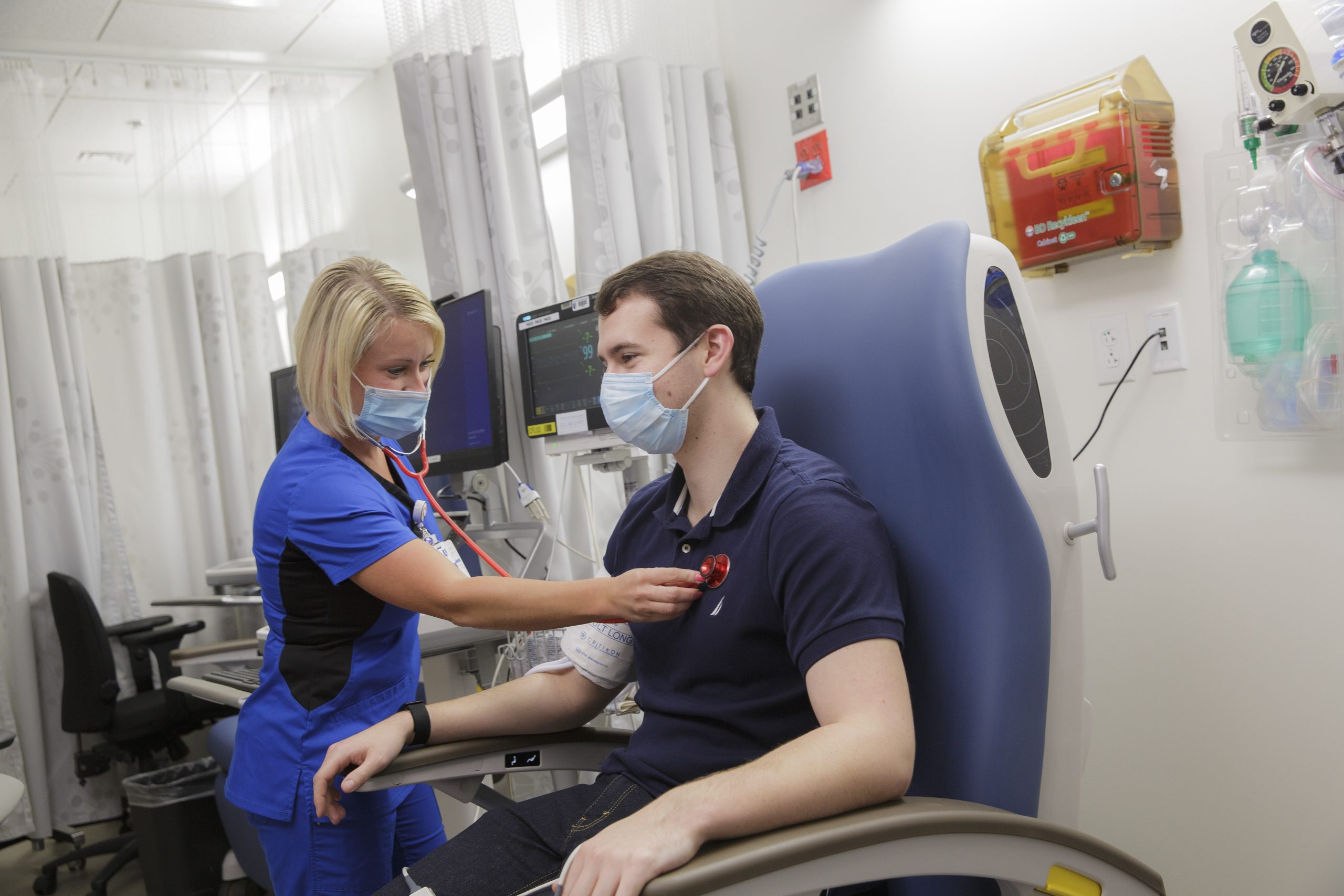 Nurse with a stethoscope on a patient