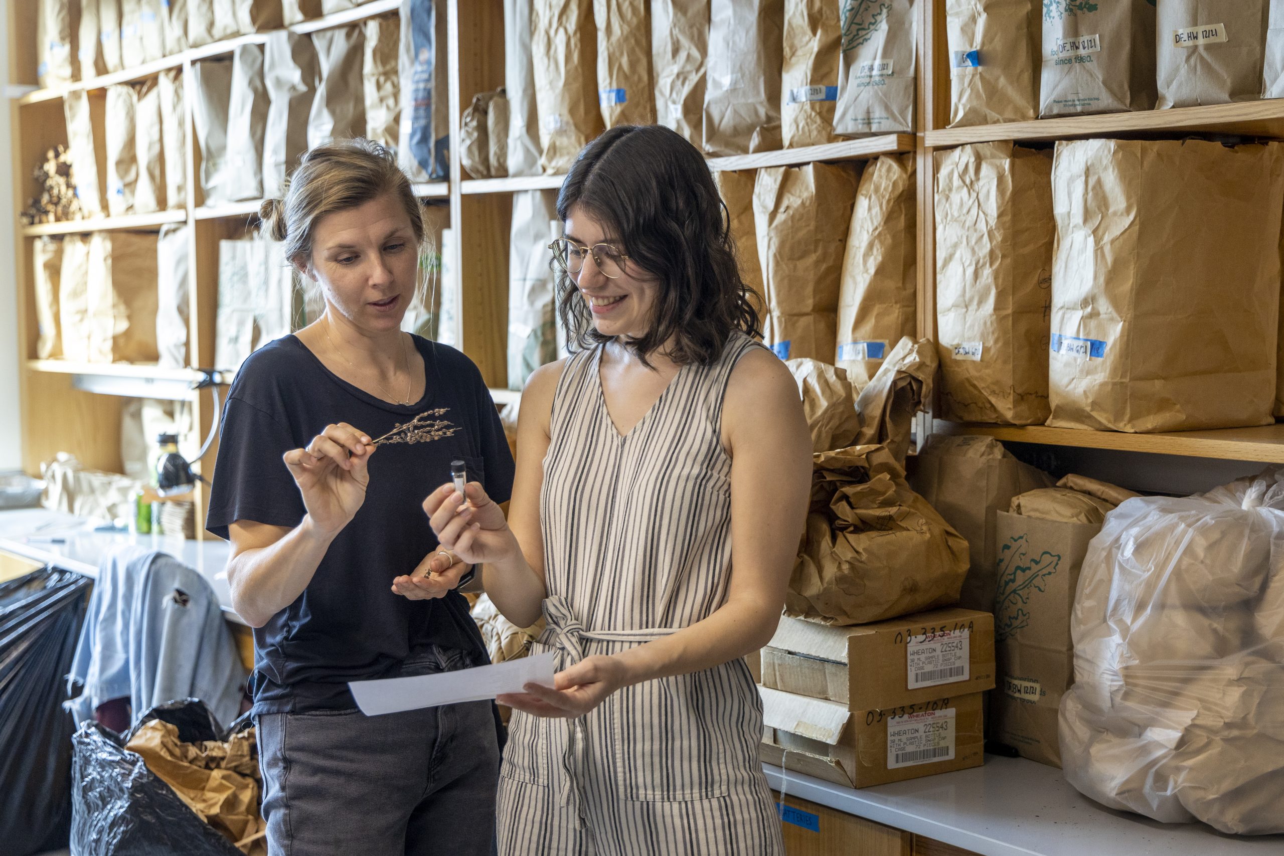 Jordan Luongo and Samantha Sutton of Jim Clark's lab looking at plant seeds.