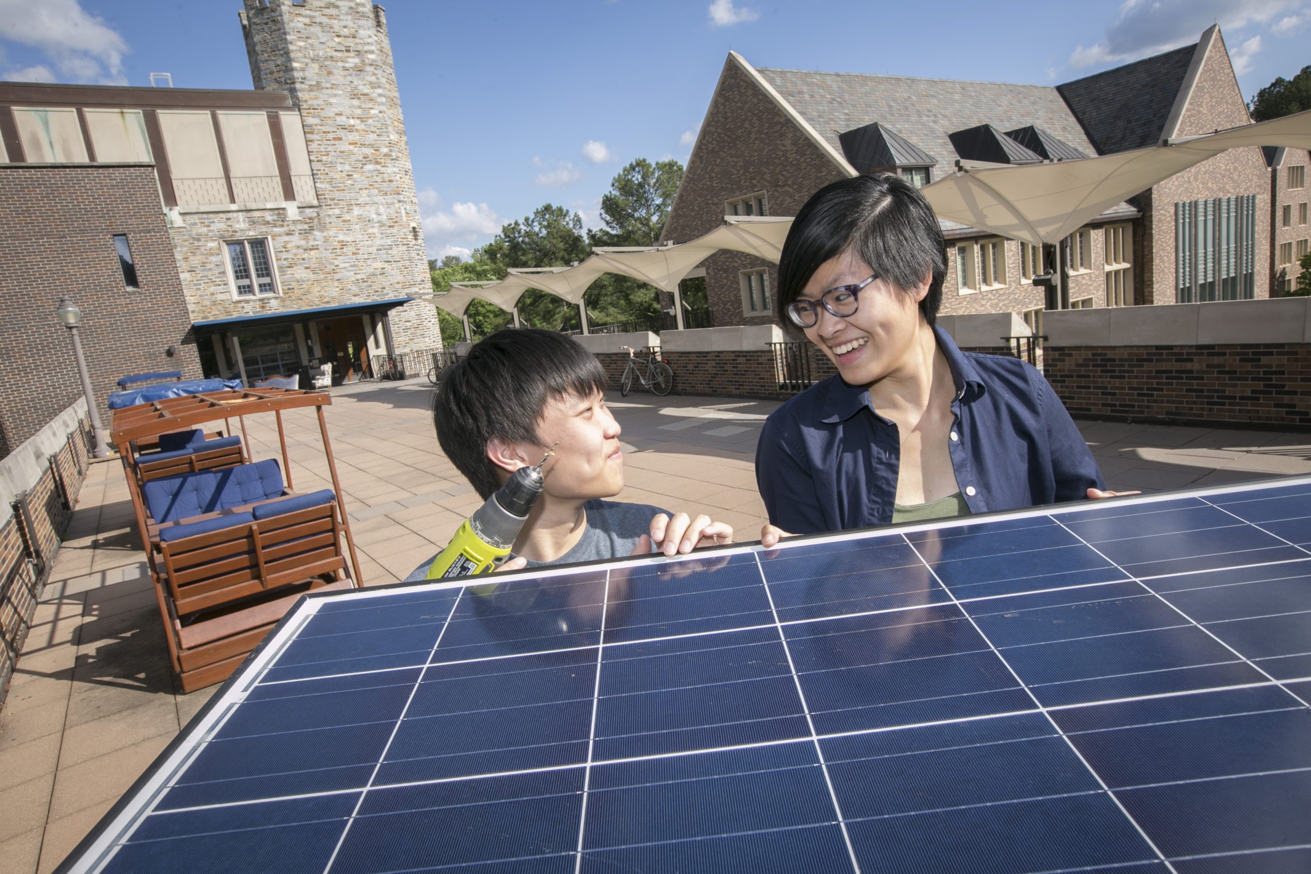 Two Duke students looking at a solar panel.