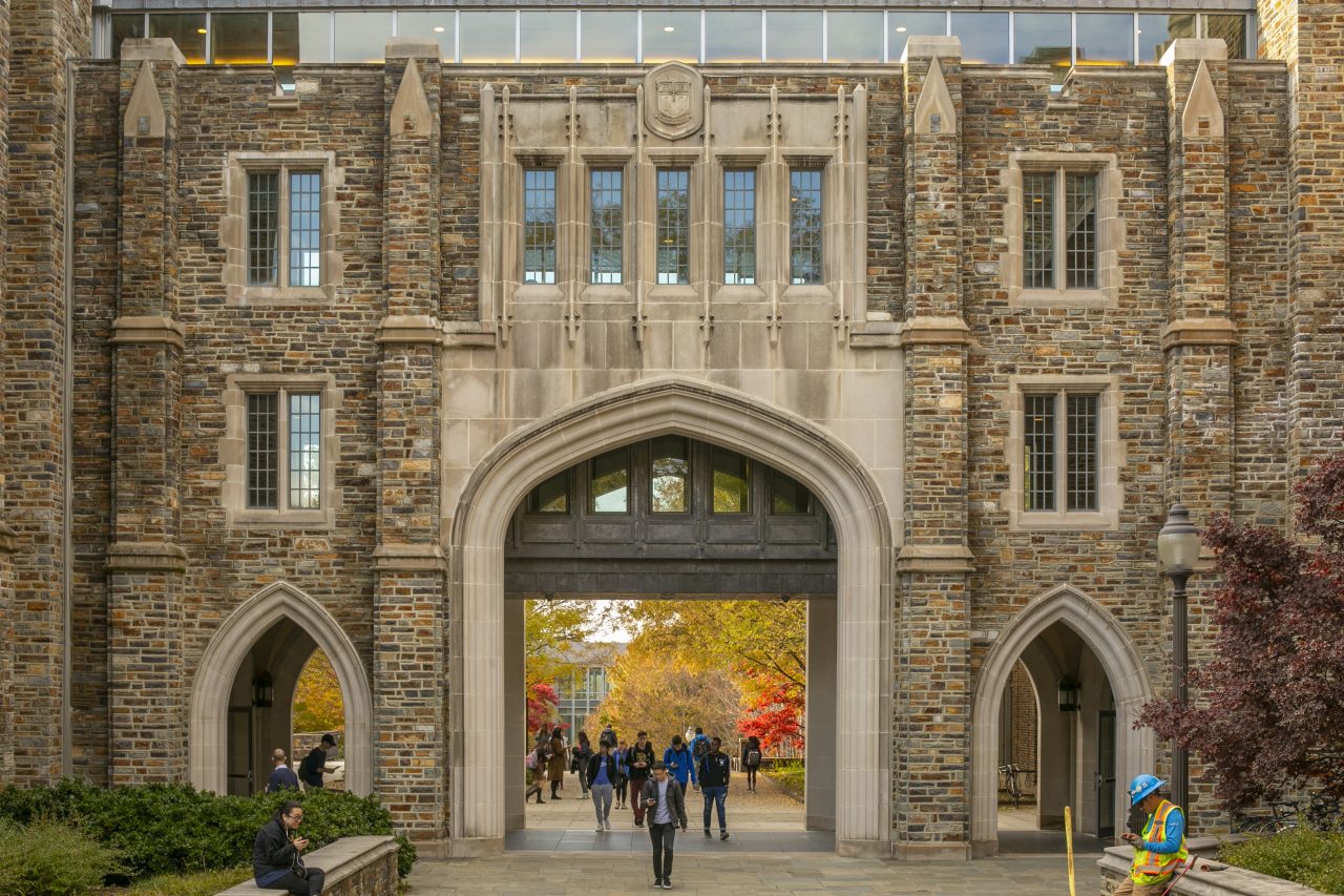 Exterior of Perkins Library with members of the Duke community walking by.