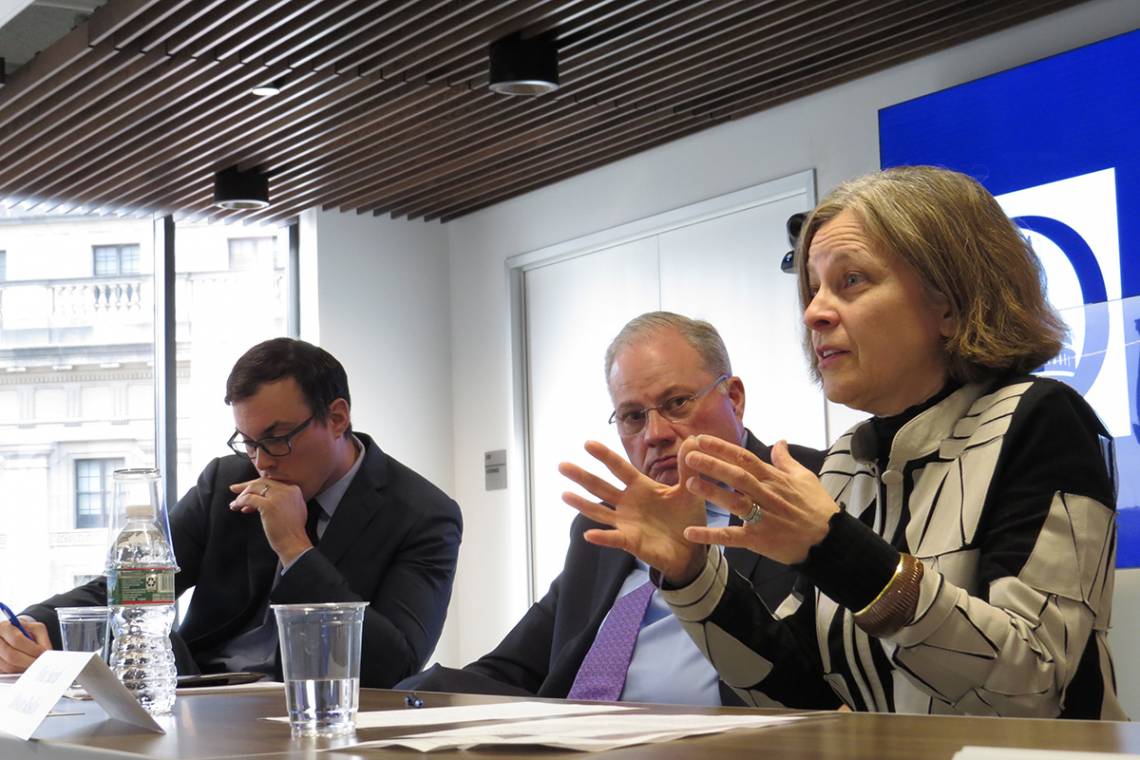 Sarah Bloom Raskin speaking at a table with two other people