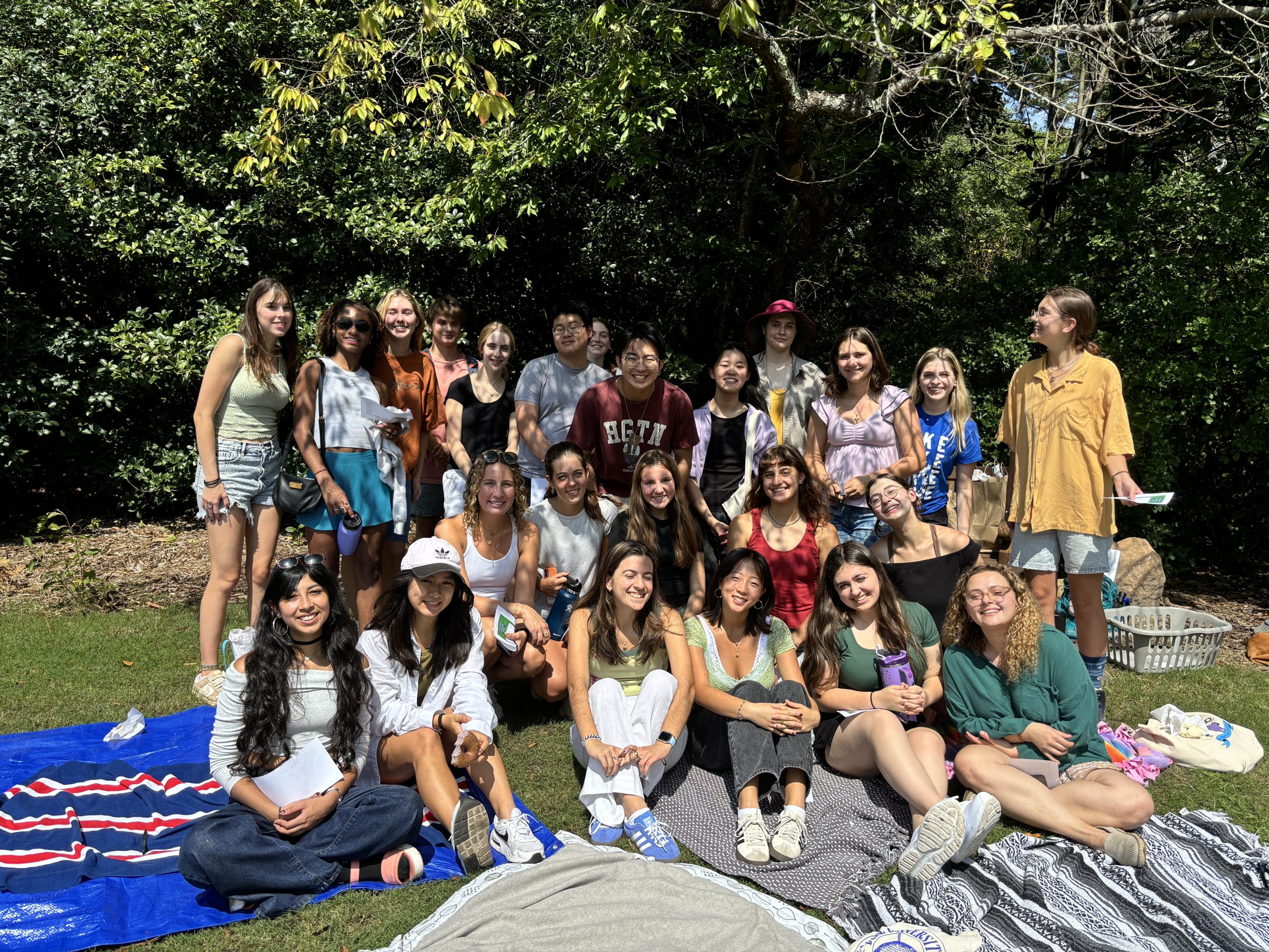 group of sustainability ambassadors some seated and others standing outside
