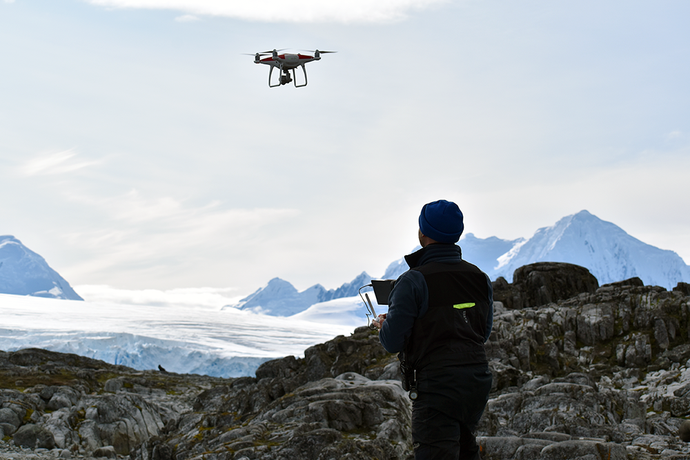 Flying a drone in Antarctica (Photo: Courtesy of Greg Larsen)