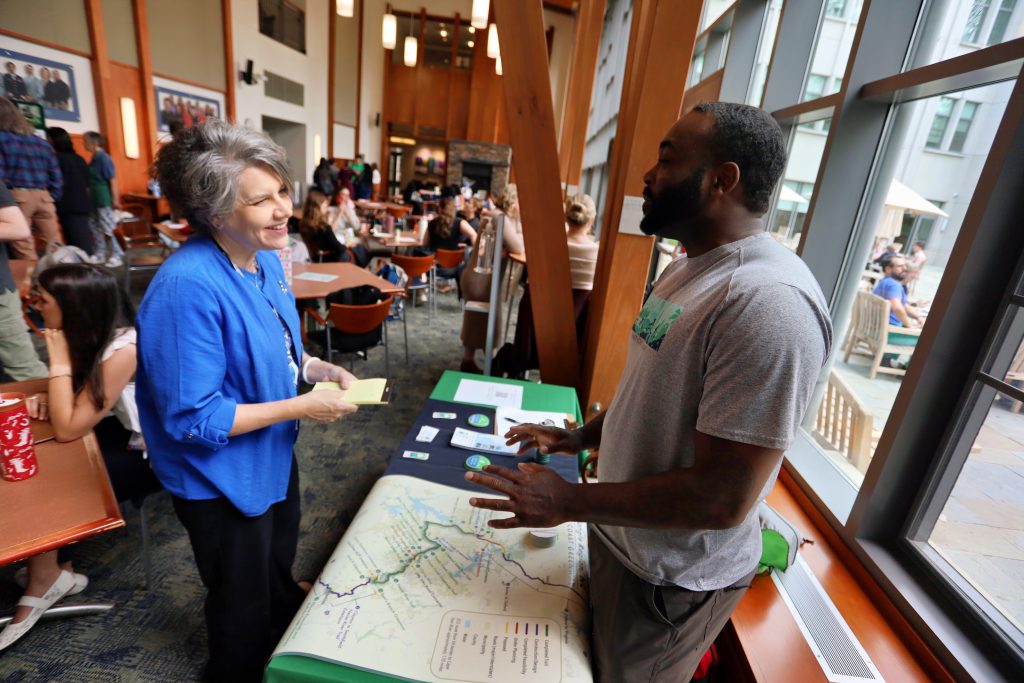 Valerie Sabol at planetary health fair talking to another person